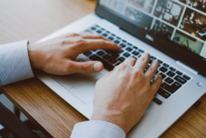 hand typing on laptop's keyboard